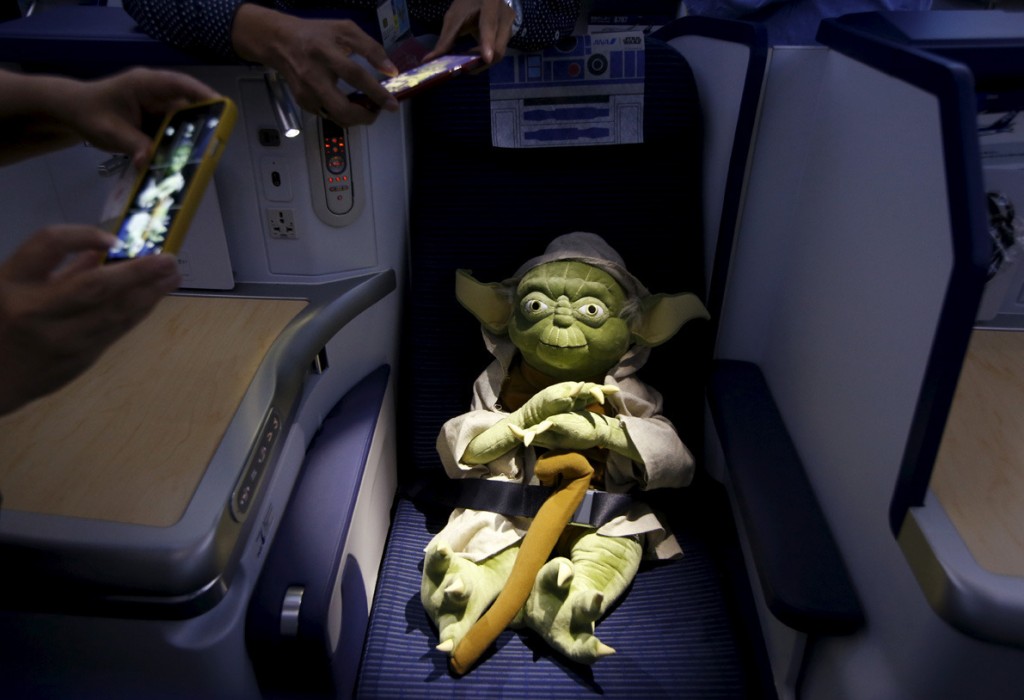 Image #: 40769506    Visitors take photos of a Yoda plush toy sitting in the business class section during a tour of the Star Wars themed All Nippon Airways ANA R2D2 Boeing 787 Dreamliner aircraft at Singapore's Changi Airport November 12, 2015. The aircraft was opened to the media on Thursday as it makes its first Asian stop outside Japan. REUTERS/Edgar Su  /LANDOV