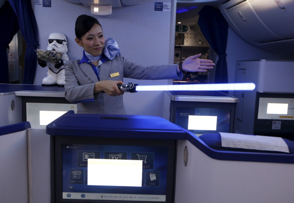 Image #: 40769587    A stewardess holding a lightsabre explains the features of the business class section during a tour of the Star Wars themed All Nippon Airways ANA R2D2 Boeing 787 Dreamliner aircraft at Singapore's Changi Airport November 12, 2015. The aircraft was opened to the media on Thursday as it makes its first Asian stop outside Japan. REUTERS/Edgar Su  /LANDOV