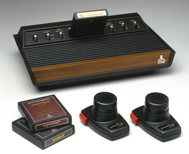 UNITED STATES - MARCH 02: The first plug-in cartridge computer game was introduced by the Fairchild Camera and Instrument Corporation in the United States in 1977. Unlike earlier TV games, the plug-in cartridges contained eprom (a silicon chip memory) loaded with different information for every game. This meant that the console could be continuously renewed by simply plugging in a new games cartridge. Atari had been developing their own prototype programming system along similar lines and in October 1977 launched the Atari Video Computer System, which remained one of the most popular video game systems until the mid 1980s. The console is shown here with three popular games: ?Space Invaders?, ?Superman? and ?Breakout?. (Photo by SSPL/Getty Images)